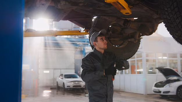 garage-automobile-service-mechanic-bottom-car-checks-wheel